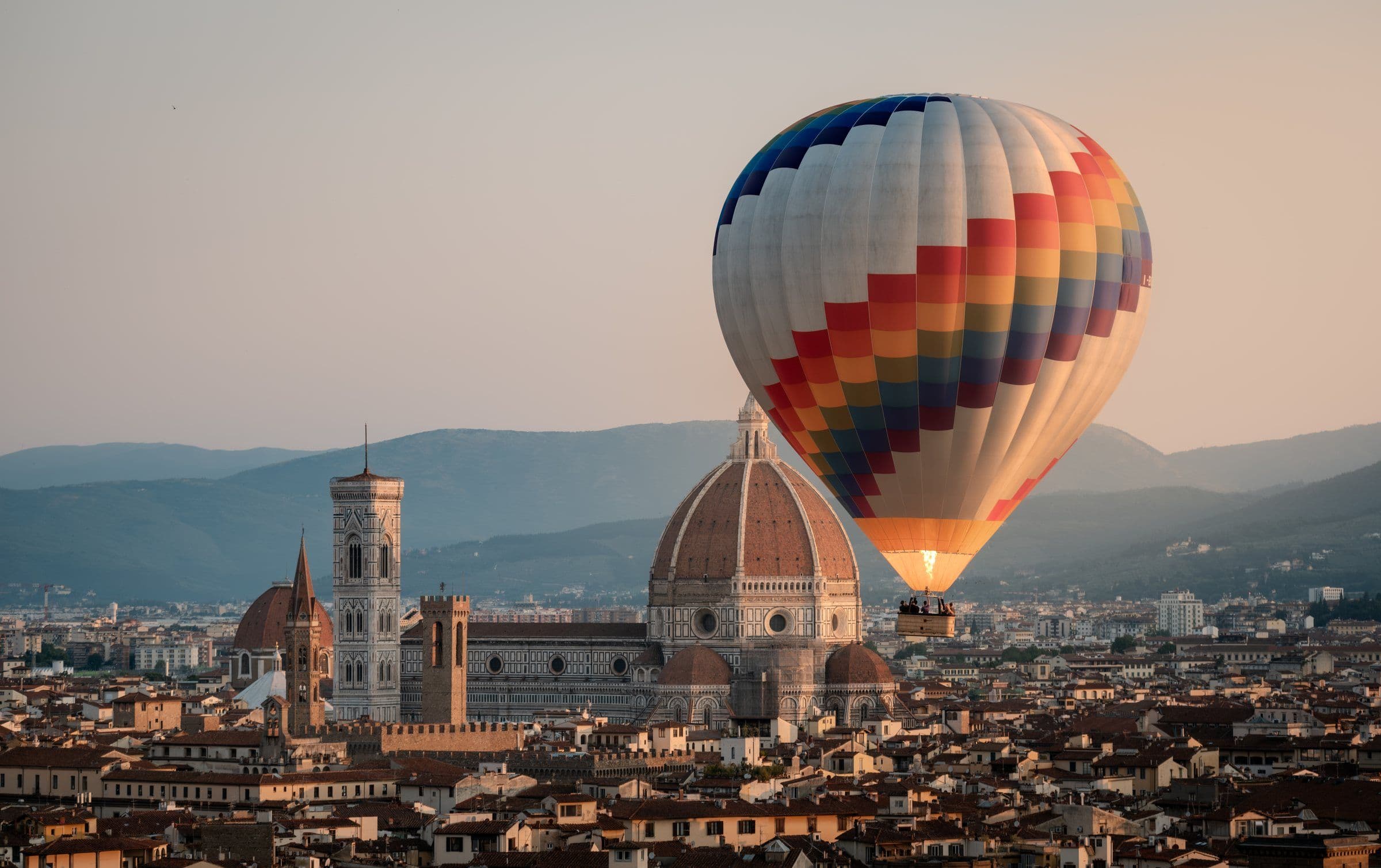 A hot-air balloon drifting past the Duomo in Florence